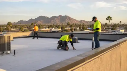 Commercial roofing crew inspecting a flat roof